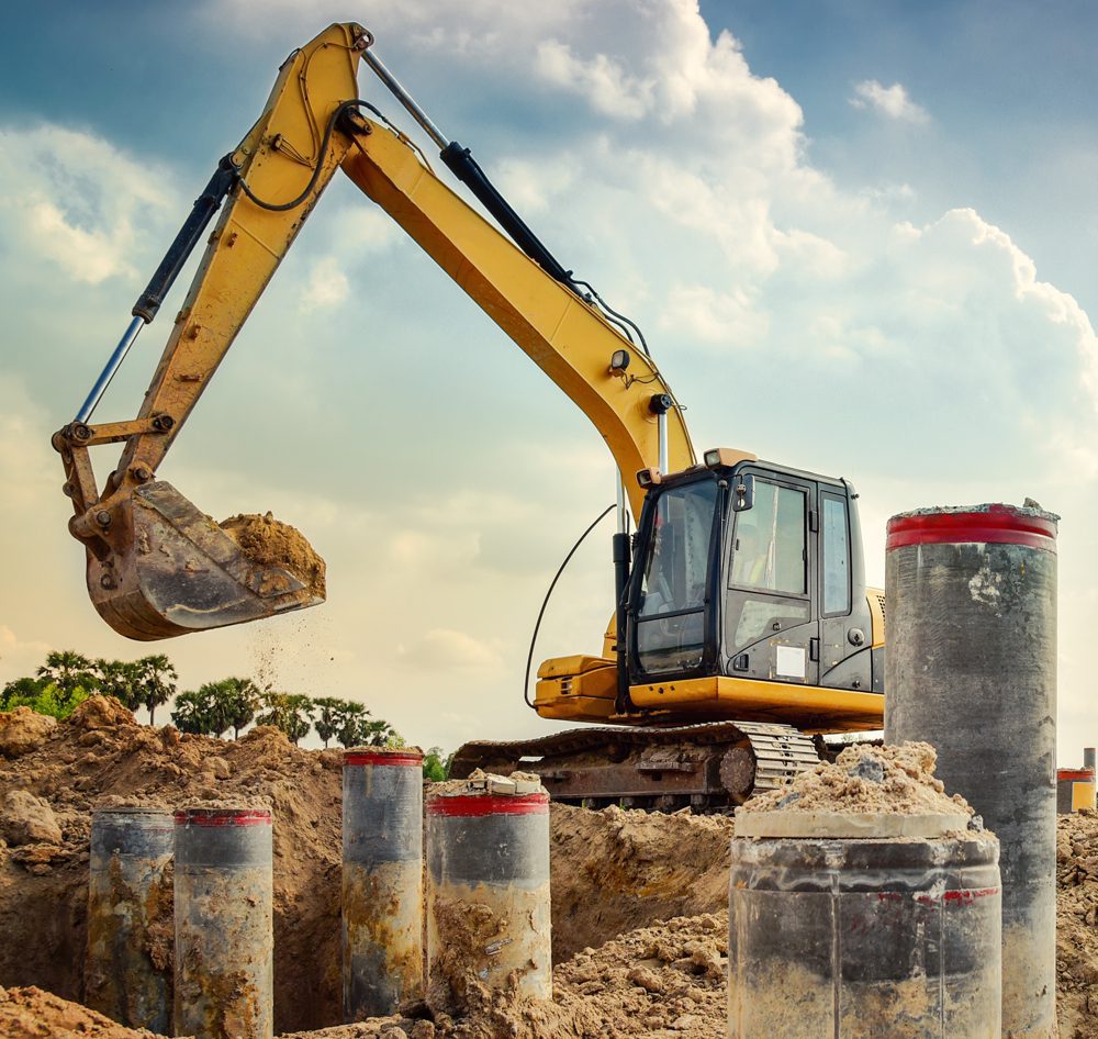 digging-foundation-GettyImages-940119506 Overholt Grading - digging ground around pillars at a site